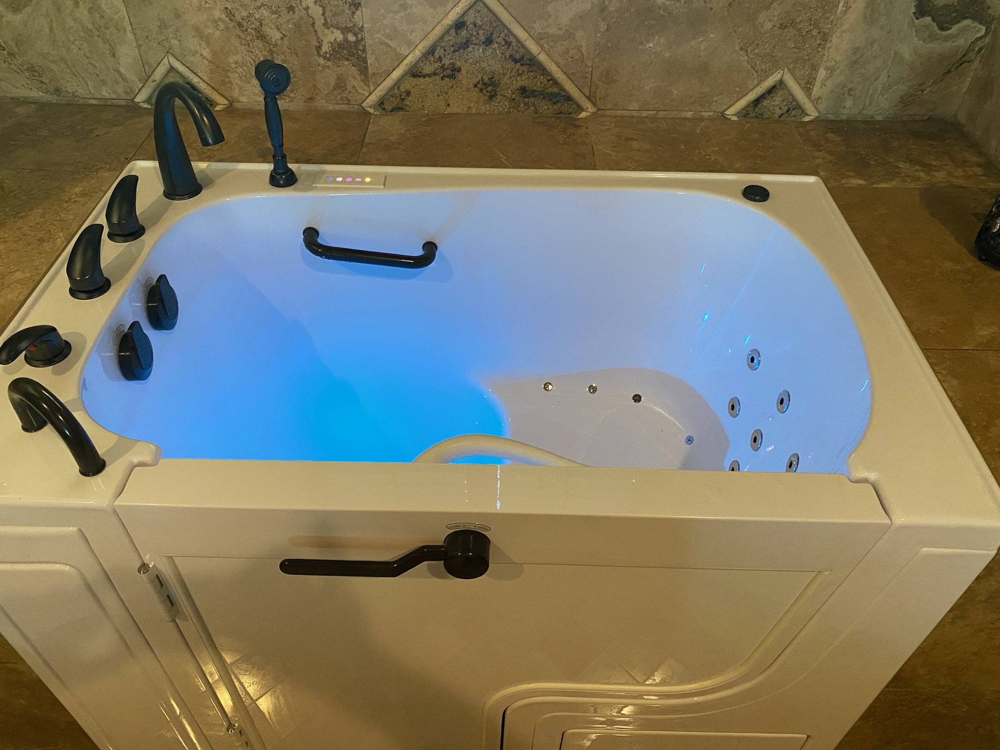 Photo of walk in tub with blue lights.